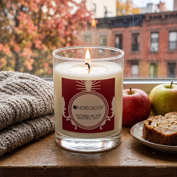 Autumn in the Electric City Candle burning on a windowsill in a city apartment on a crisp autumn afternoon | Noteology
