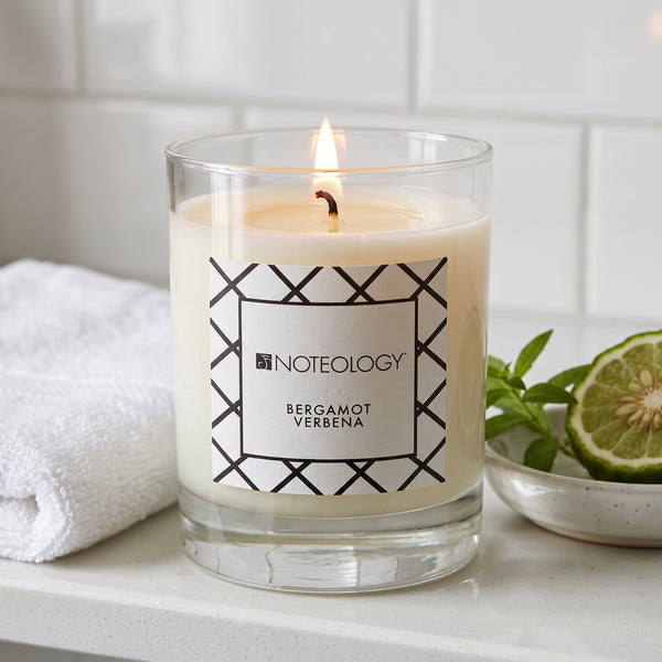 Bergamot Verbena Candle burning on a bright bathroom shelf in soft morning light | Noteology