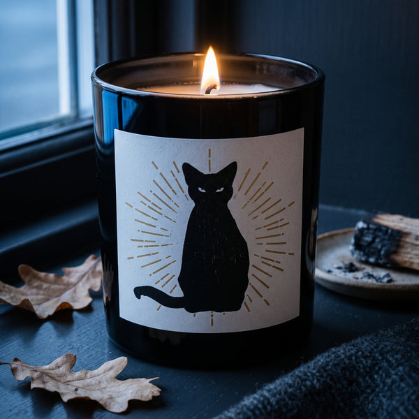 Black Magic Candle burning on a dark painted windowsill at dusk | Noteology
