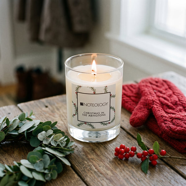 Christmas in the Abingtons Candle burning on a wooden farmhouse bench in a front hall at Christmas | Noteology
