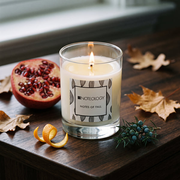 Notes of Fall Candle burning on a dark wood sideboard in soft side light | Noteology