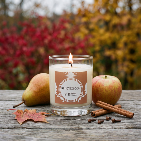 Scranton in the Fall Candle burning on a porch table outdoors in soft overcast light, red and gold leaves | Noteology