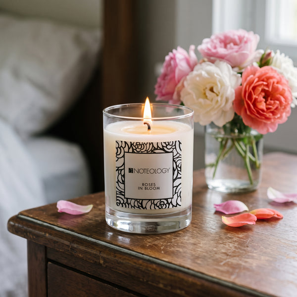 Roses in Bloom Candle burning on a bedroom dresser in soft window light | Noteology